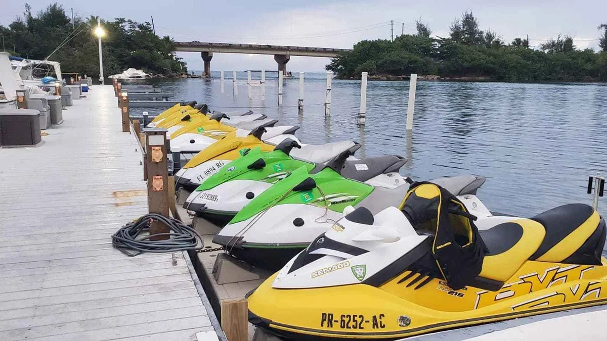 Riders on a guided jet ski tour crossing the San Jose Lagoon toward Isla Verde on a jet ski rental in Puerto Rico