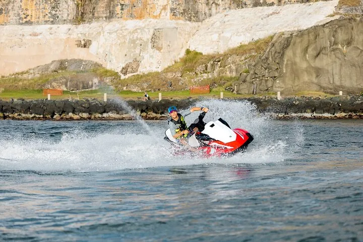 Jet ski crossing San Juan Bay with the Old San Juan skyline behind on a jet ski rental in Puerto Rico