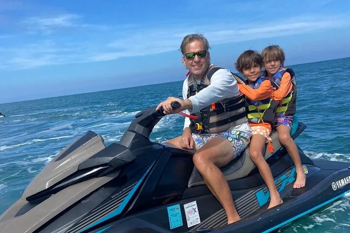 Parent and two children on a family jet ski tour in San Juan Bay on a jet ski rental in Puerto Rico